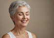 © DariaTrofimova - Portrait of a beautiful middle-aged gray-haired woman with closed eyes on a gray background