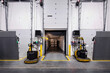 © Francisco - Interior of warehouse loading dock, with truck parked loading and two electric fork lifts on each side