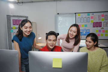 group of young asian uiux designers and developers working together on a new mobile app in the offic