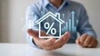 © Mahmuda - Businessman displaying a home icon with percentage symbol and rising financial growth charts