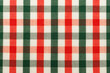 © Gudman - The texture of linen fabric in a large cage of green, red and white. Scottish tailoring material. Checkered fabric