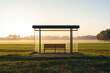 © Timo - Lonely rural bus shelter at sunrise with misty field and forest backdrop
