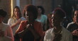 © Marco - Diverse group of Christian worshippers in prayer, hands on hearts, eyes closed, deep spiritual connection in evangelical congregation