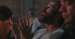 © Marco - Man with red beard raising hands in worship, looking upward in devotion, deep spiritual connection and moment of heartfelt prayer during a group gathering