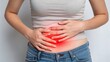 © ANNetz_PK - Gut Health and IBS Symptoms – Digestive Wellness Concept, A young woman grimaces in pain, holding her stomach, conveying strong emotion in a close-up shot.