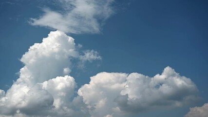 Wall Mural - Timelapse of dramatic building cumulus storm clouds in a bright blue sky
