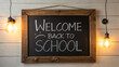 © islam bepari - Welcome back to school chalkboard sign with vintage light bulbs on wooden wall