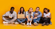 © Prostock-studio - Tired international students getting ready for exams, asian girl with laptop having idea, yellow background, panorama