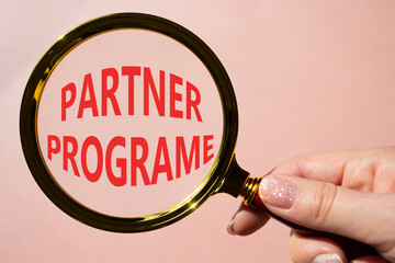partner program symbol. concept words partner program on magnifying glass. businessman hand. beautif