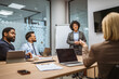 © Miljan Živković - Mature businesswoman present new project to her colleagues in office