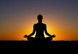© Nazrul - Silhouette of woman meditating against sunset sky