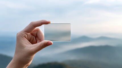 Poster - Transparent Acrylic Business Card with Rounded Corners Held by Hand Against Soft Blurred Background for Modern Branding and Innovative Professional Identity