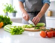 © Lepo - Person chopping celery in a kitchen (1)