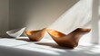 © Juan - Stylish wooden bowls and folded napkin in sunlight editorial rustic minimal clean kitchen decor image
