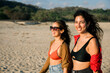 © Westend61 - Two friends enjoying a sunny day at the beach wearing swimwear and sunglasses