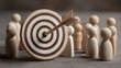 © zhao - Teamwork and Business Goals Execution. A wooden disc with a bullseye and arrow icon is placed among wooden figures, symbolizing goal setting, business strategy, leadership, and teamwork. High quality