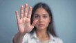 ©  Sarimo graFX - Woman showing stop hand gesture, out of focus background
