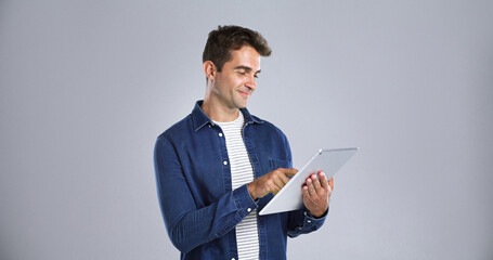 Leinwandbilder - Smile, tablet and website with man in studio for programming or software development career. App, mainframe and system maintenance with tech guru on white background space for professional IT support