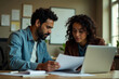 © Vii - A couple sitting together looking at a laptop screen