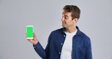 Wall Mural - man, advertising or phone with green screen in studio for new app on a white background. male person