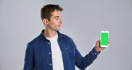 Wall Mural - man, phone screen or chromakey in studio for advertising or presentation on a white background. male