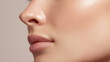 © Marut - Closeup of smooth cheekbone and lips under natural white light showing healthy skin texture and soft natural beauty with subtle shine and delicate pores