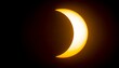 © Khozinul - A captivating photograph showcasing a partial solar eclipse with a vibrant crescent of sunlight against a dark, celestial backdrop, creating a dramatic visual.