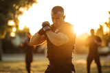 Krav Maga training session taking place outdoors as the sun sets - creating a dramatic backdrop to the intensive workout 