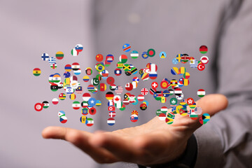 Aufkleber - Diverse flags floating above a hand, symbolizing global connections and international collaboration.