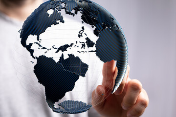 Poster - High-quality stock photo of a person interacting with a 3D digital globe, symbolizing global connections and international business.