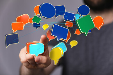 Aufkleber - Hand interacting with colorful speech bubbles, representing communication and networking.