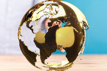 Fototapete - Image of a golden globe, symbolizing international business, networking, and global reach.
