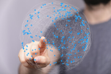 Fototapete - Abstract image of a hand interacting with a digital sphere representing global network connections.