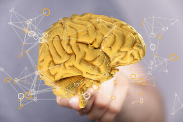 Poster - 3D rendering of a golden brain with interconnected nodes, representing neural networks and cognitive processes.