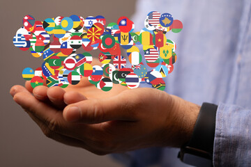 Aufkleber - Image of hands gently holding a collection of diverse national flags, symbolizing global unity and international relations.