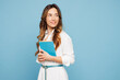 © ViDi Studio - Sideways young successful employee business woman corporate lawyer wears shirt classic formal clothes work in office hold book notebook look aside isolated on pastel blue background studio portrait.