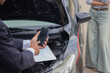 © NANKHAMMAI - Smartphone users take photos of damaged vehicles to file insurance claims, retaining evidence of accidents for legal, safety, and repair assistance.