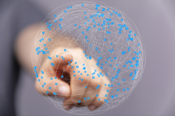 Leinwandbilder - Abstract image of a hand interacting with a digital sphere representing global networking and connectivity.
