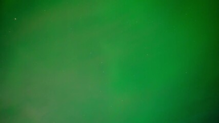 Wall Mural - shade of bright green aurora northern lights in a starry sky including the big dipper and drifting c