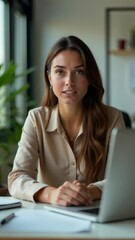 Poster - a woman sits at a desk with a laptop computer, focused on her work