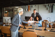 © Miljan Živković - Confident senior businesswoman share documents with colleagues