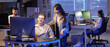 © Pixel-Shot - Male programmer working with his colleague in office at night