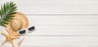 © Pixel-Shot - Summer composition with sunglasses and beach hat on white wooden background with space for text