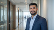 © Frederick - young age middle eastern businessman standing in hallway of modern office, successful arabic business man portrait, saudi corporate manager, assistant to ceo, starter newcomer
