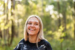 © Austockphoto - Young aboriginal woman in her twenties laughing in green bushland
