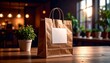 © H - Brown Paper Shopping Bag Mockup with Blank Tag on Wooden Table