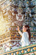 © StockPhotoRepublic - Young Woman in Traditional Thai Dress at Wat Arun, Temple of the Dawn, Bangkok, Thailand