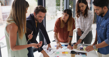 Poster - Group, creative business people and discussion with document for brand strategist. Team meeting, manager and collaboration in startup office for planning, proposal and strategy for ad campaign design