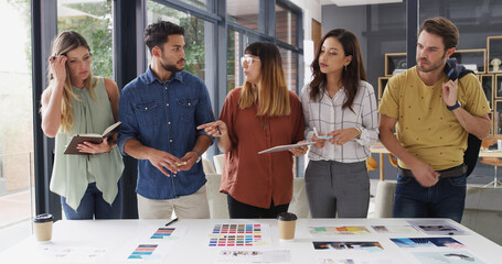 Poster - Meeting, color swatches and business people in office with creative project for magazine publishing. Discussion, teamwork and group of designers with documents for ideas, planning or collaboration.