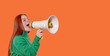 © Iryna - Young woman enthusiastically uses a megaphone while promoting a cause against a vibrant orange backdrop